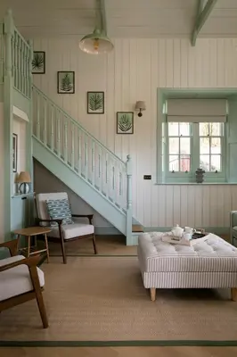 a living room with a couch and a staircase at Montagu in Thornhill