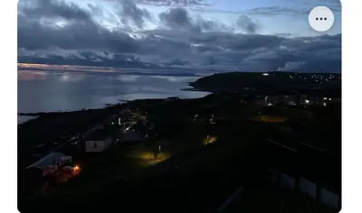 a view of a body of water at night at Beach villa in Parton