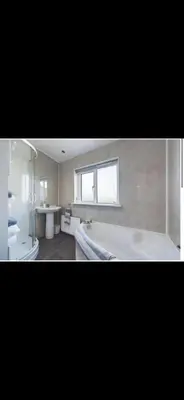 a large bathroom with a tub and a sink at Beach villa in Parton
