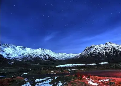 a view of a snowy mountain at night at Stylish retreat in Langdale in Chapel Stile