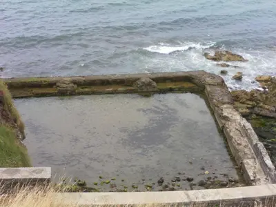 a large pool of water next to the ocean at isleofmanholidayapartment in Douglas