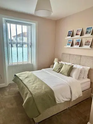 a bedroom with a large bed with a window at Prestwick KingB PetsOk FreeP Wifi Tv in Prestwick