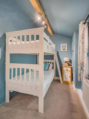 a bedroom with a white bunk bed in a room at 4 Bed in Ulpha SZ183 in Ulpha