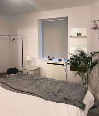 a bedroom with a large bed and a window at Lakes Loft in Cockermouth