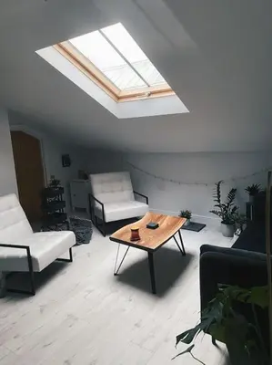 a living room with a skylight and a coffee table at Lakes Loft in Cockermouth
