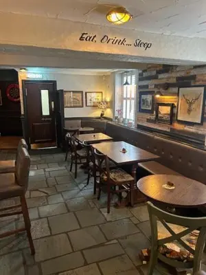 a restaurant with tables and chairs in a room at The White Lion Inn in Penrith