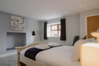 a bedroom with a bed with two towels on it at Family friendly farmhouse with games and cinema room in Glencaple