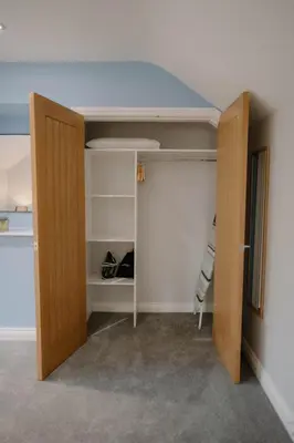 a closet with a door open in a room at Family friendly farmhouse with games and cinema room in Glencaple