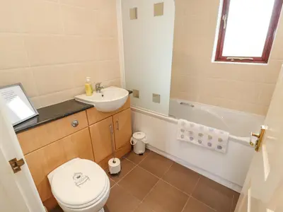 a bathroom with a toilet and a sink and a tub at Valley View in Cleator Moor