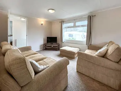 a living room with two couches and a television at Lisset in Newton Stewart