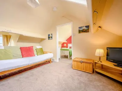 a bedroom with a bed and a flat screen tv at The Gables in Keswick