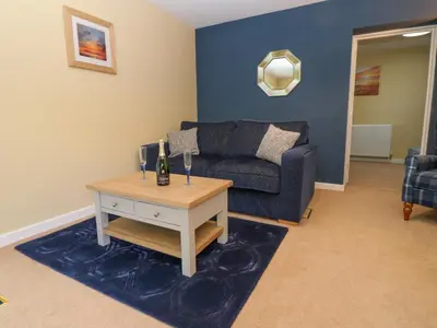 a living room with a couch and a table at The Nest in Carlisle