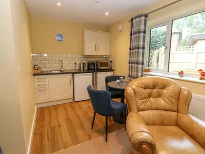 a kitchen with a couch and a table in a room at The Nest in Carlisle