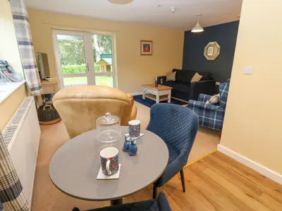 a living room with a table and chairs at The Nest in Carlisle