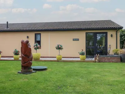 a house with a statue in the yard at The Nest in Carlisle