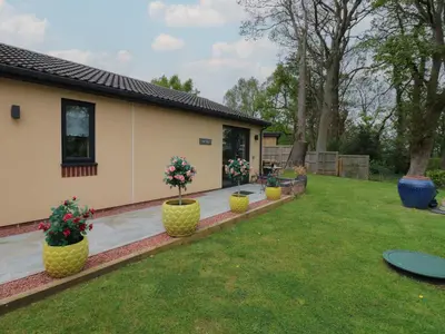 a house with flower pots in the yard at The Nest in Carlisle