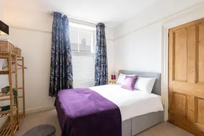a bedroom with a large bed and a window at Hampton Manor House - 9 Bedrooms in St Bees