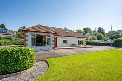 a house with a lawn in front of it at Anthony House in Kippford