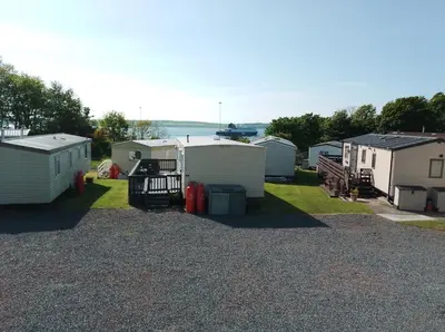 a group of mobile homes parked in a yard at Cairnryan - Loch Ryan View in Cairnryan