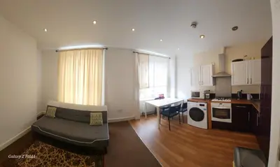 a small living room with a couch and a kitchen at Flat 2 Douglas Head Road in Douglas