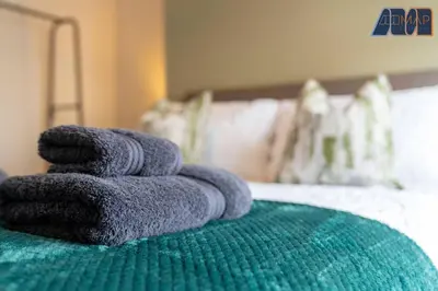 a pile of towels sitting on top of a bed at Carlisle 3Bed Sleeps 6 in Carlisle