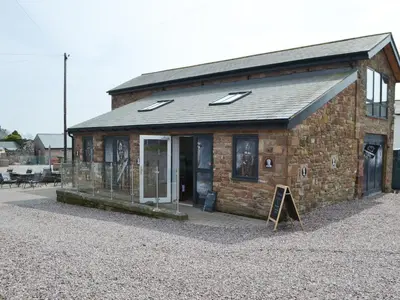 a brick building with a sign in front of it at Haaf Netters Rest - Uk43557 in Bowness-on-Solway