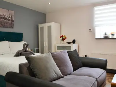 a living room with a couch and a bed at Haaf Netters Rest - Uk43557 in Bowness-on-Solway