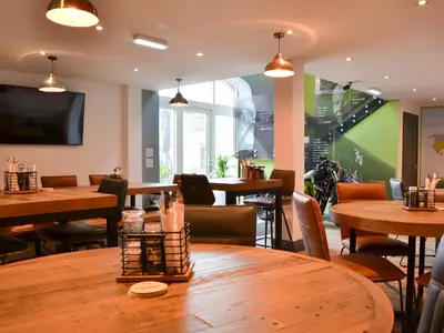 a dining room with tables and chairs and a tv at Sian's Shepherds Hut - Uk43561 in Bowness-on-Solway