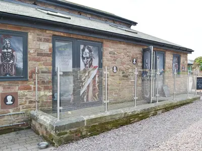 a brick building with posters on the side of it at Sian's Shepherds Hut - Uk43561 in Bowness-on-Solway