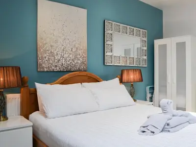 a bedroom with a bed with a towel on it at John Collingwood Bruce Suite - Uk43558 in Bowness-on-Solway