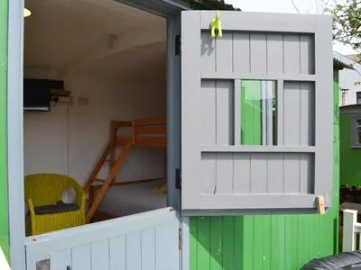 ajar door of a play house with a bunk bed at Hannah's Shepherds Hut - Uk43564 in Bowness-on-Solway