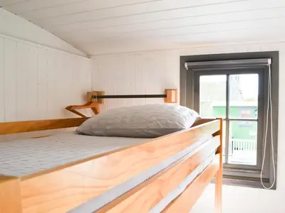a bed in a small room with a window at Jamie's Shepherds Hut - Uk43566 in Bowness-on-Solway