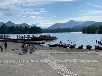 a group of people standing on the shore of a lake at Stanleys Sanctuary, Lake District in Plumbland