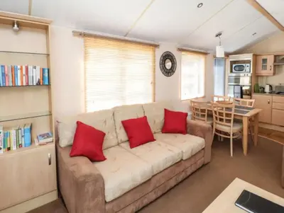 a living room with a couch with two red pillows at Stanleys Sanctuary, Lake District in Plumbland