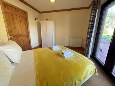a bedroom with a bed with a yellow blanket at Beautiful 5BR House near Gretna Green with Garden - Pass the Keys in Kirkpatrick Durham