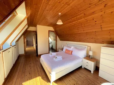 a bedroom with a white bed and a wooden ceiling at Beautiful 5BR House near Gretna Green with Garden - Pass the Keys in Kirkpatrick Durham