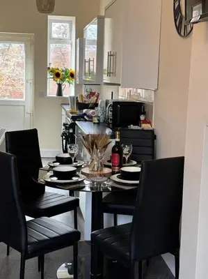 a kitchen with a table with chairs and a tableasteryasteryasteryasteryasteryastery at Quay cottage Annan in Annan