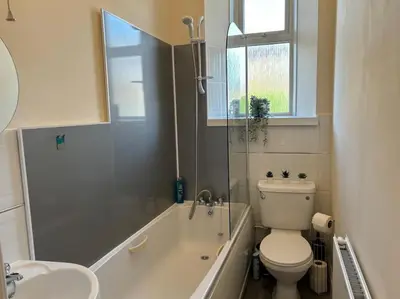 a bathroom with a toilet and a tub and a sink at Quay cottage Annan in Annan