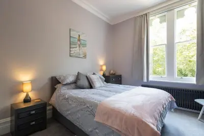a bedroom with a bed and two windows at Host & Stay - Chatsworth Townhouse I in Carlisle