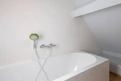 a bathtub with a shower head in a bathroom at Host & Stay - Chatsworth Townhouse I in Carlisle