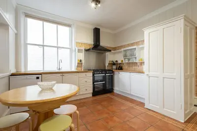 a kitchen with a table and some chairs in it at Host & Stay - Chatsworth Townhouse II in Carlisle