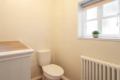 a bathroom with a white toilet and a window at Host & Stay - Chatsworth Townhouse II in Carlisle