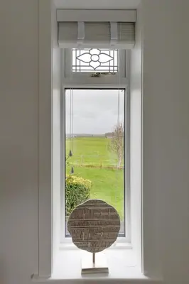 a window with a view of a green field at The Paddock at Brickrow Farm in Ayr