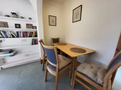 a dining room with a wooden table and chairs at Wheelwrights House in Ambleside