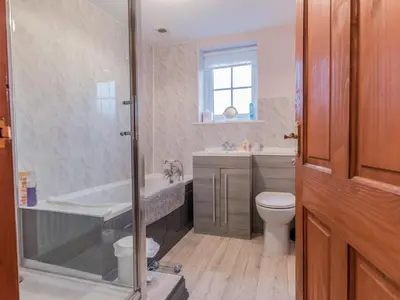 a bathroom with a tub and a toilet and a sink at Stanwix Cottage in Carlisle