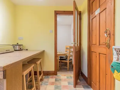 a kitchen with a counter and a table at Stanwix Cottage in Carlisle