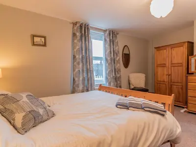 a bedroom with a bed and a window at Stanwix Cottage in Carlisle