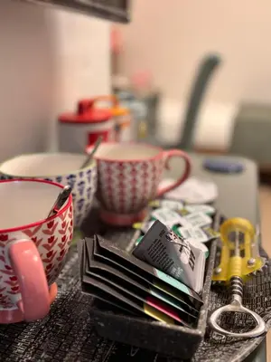 a table with cups and books on a counter at Cartref Guest House in Carlisle