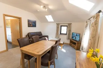 a dining room with a wooden table and chairs at Crookabeck B&B in Patterdale