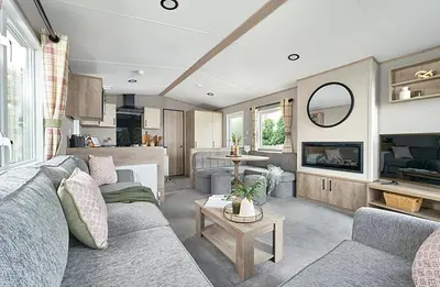 a living room with a couch and a table at Queensberry Bay Essential Clover Caravan Pet in Annan